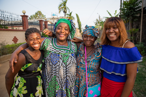 multigenerational group of female african friends together hugging and laughing, African women