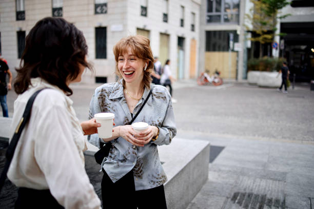 istock Businesswomen talking outside during coffee break 1408974616