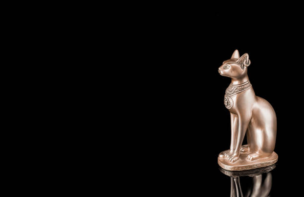 istock Egyptian cat statue isolated on black background 1408975416