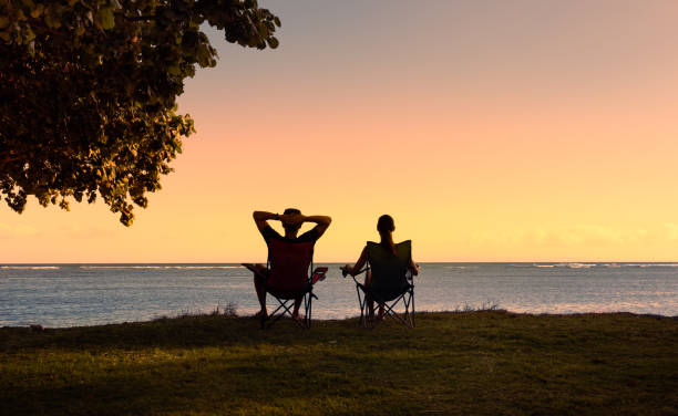 istock Couple relaxing in the chairs at the beach. 1408975564