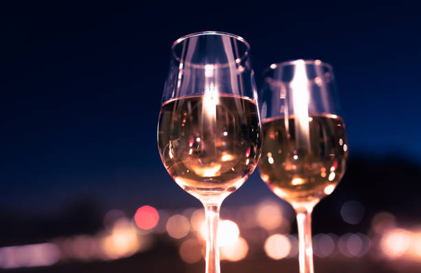 istock Wineglasses in the city at night. 1408975657