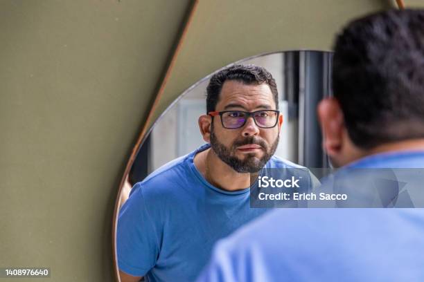 A Man With Glasses Looks At Himself In The Mirror At A Barbershop In Novo Hamburgo Stock Photo - Download Image Now
