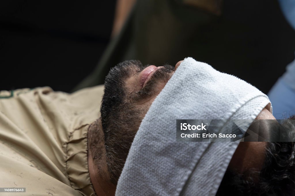 Man lying down with a towel getting ready to shave, Novo Hamburgo barbershop Man lying down with a towel getting ready to shave, Novo Hamburgo barbershop, RS, Brazil 45-49 Years Stock Photo