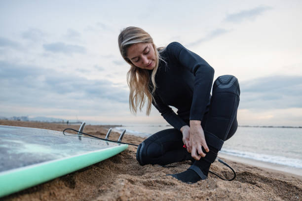 istock Female Surfer Attaching Safety Leash To Her Ankle 1408982810