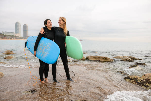 istock Cheerful Female Surfers Laughing At Barceloneta Beach 1408982856