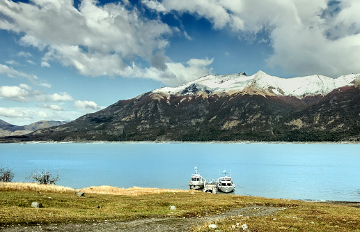 Boats in Lago Argentino, at a pier near the Perito Moreno Glacier, El Calafate, Santa Cruz Province, Patagonia, Argentina.