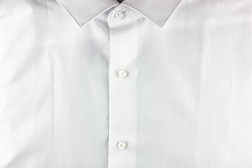The White dress shirt without pockets.White men's shirt with buttons collar.Business shirt shirt white high definition texture.