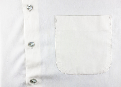 The White shirt shirt and pocket close-up. Men's shirt with a pocket, buttoned up.