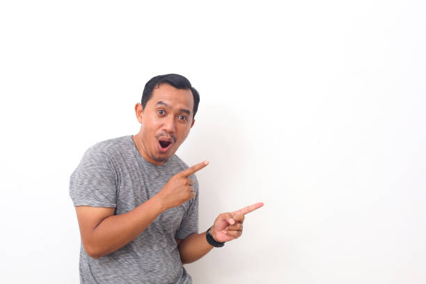 istock Portrait of asian man pointing something on empty space. Isolated on white with copyspace 1408999084