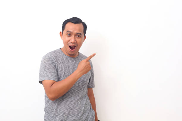 istock Portrait of asian man pointing something on empty space. Isolated on white with copyspace 1408999088