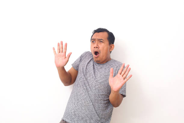 istock Portrait of scared asian man isolated over white. 1409000464