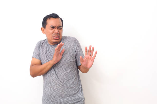 istock Asian man with disgusted expression repulsing something. Disgust concept. Emotional man. Human emotions, facial expression concept. Isolated on white background 1409000555