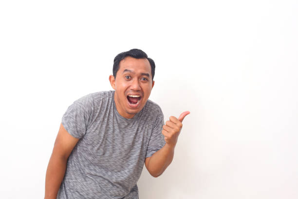 istock Portrait of asian man pointing something on empty space. Isolated on white with copyspace 1409001199