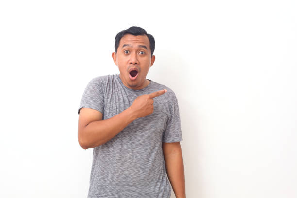 istock Portrait of asian man pointing something on empty space. Isolated on white with copyspace 1409001230