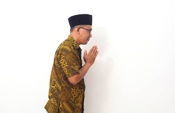 istock Asian man with greeting and welcoming gesture. Isolated on white background 1409004322