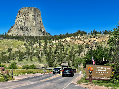 Devils Tower, Wyoming, USA - July 8, 2022: The large geographic icon known as “Devils Tower” looms in the background at the entrance to Devils Tower National Monument in northwest Wyoming.