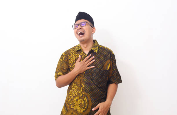 Asian man feeling suffering and using hand for touching on chest for checking about his heart attack symptom , mental health care concept
