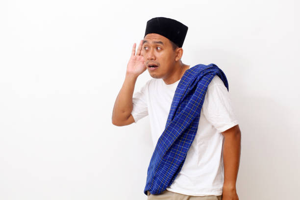 istock Portrait asian man standing while listening something with hand hold ear. Isolated on white background 1409010240