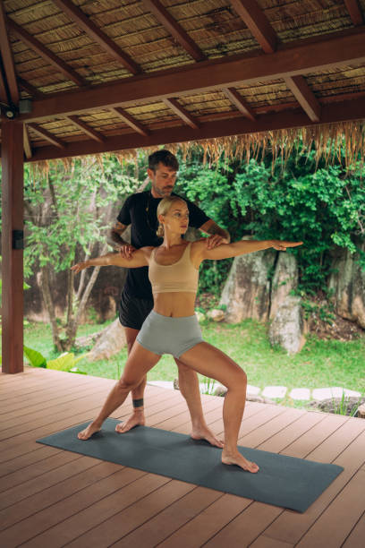 istock Woman practicing yoga with an instructor 1409010823