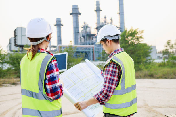 istock Two Engineers meeting for project and blueprint in working site, Construction project concept. 1409017346