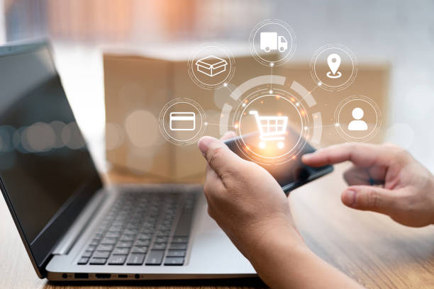 istock Transport work on virtual screen concept: Close up hand a man holding a smartphone check shopping online process deliver to customer and laptop on wood table and parcel box in blur background 1409022488