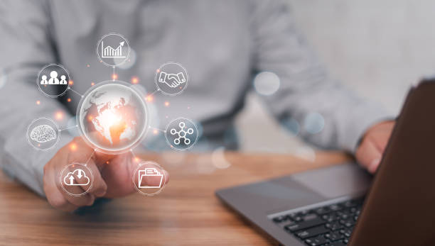 istock Business work on virtual screen concept: Businessman point Global network connection and use laptops working in an office with blur white wall in background 1409023055
