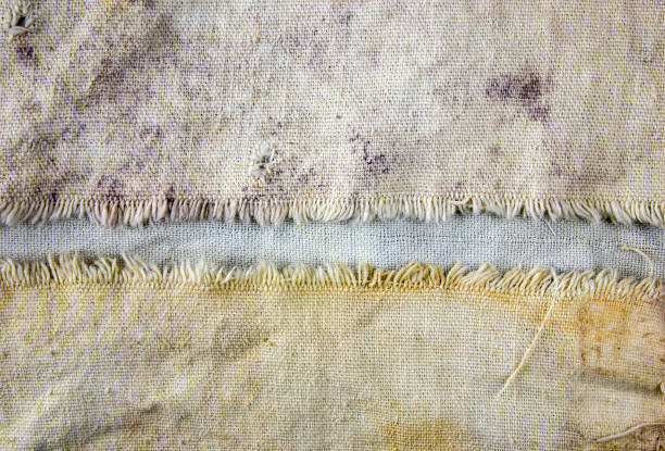 Old dirty burlap. Stained torn fabric. Authentic texture of torn dirty fabric in stains.Rotten torn linen fabric.