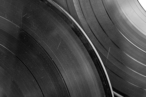The Vinyl records close-up black and white image. Vinyl background. Original authentic scratched old vinyl.