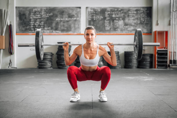 istock Sportswoman doing barbell back squat 1409026719