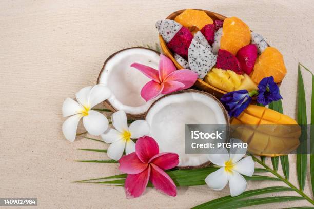 Close Up Mixed Tropical Fruit In Wooden Bowl On Palm Leaf Background Stock Photo - Download Image Now