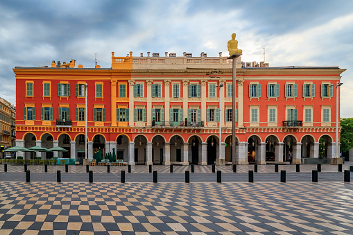 Ornate colorful buildings in Place Massena, major commercial and cultural landmark in Nice, French Riviera, South of France