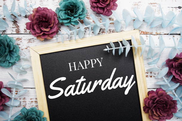 istock Happy Saturday typography text and flower dcoration on blackboard background 1409028680