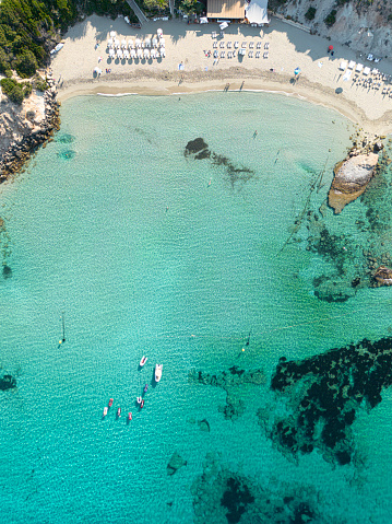 Aerial drone photos of secluded beaches and turquoise ocean in the  mediterranean sea of Ibiza, Spain