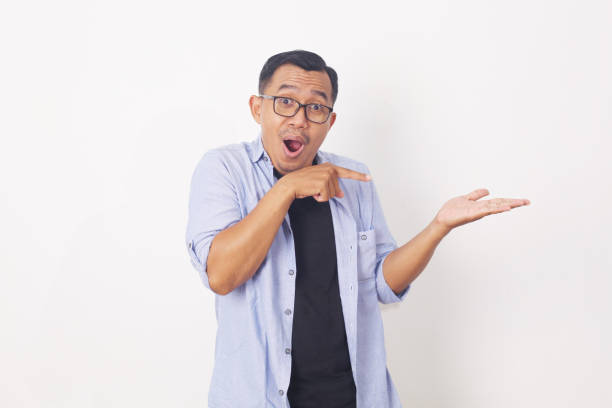 istock Portrait of asian man pointing something on empty space. Isolated on white with copyspace 1409031361