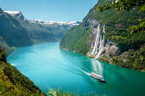 Eidfjord, Norway - June 21, 2023: Cruise ship MSC Poesia is sailing under the Hardanger Bridge