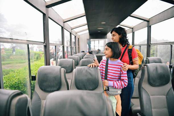 Mother and daughter standing inside a toy train in Darjeeling