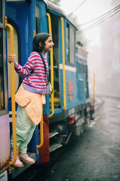 istock Girl standing at a moving train door 1409036444