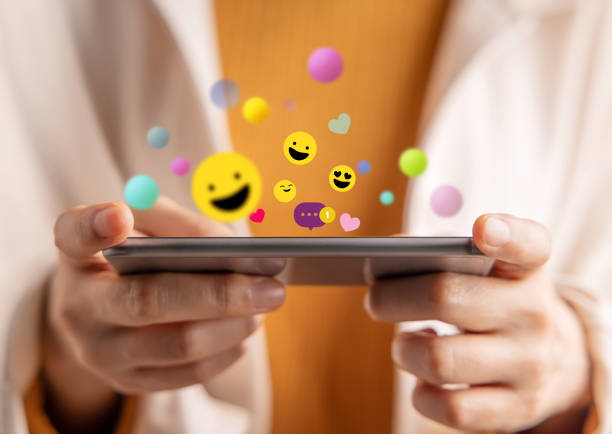 istock Psychology Personality Concept. Extrovert Person. Happiness and Enjoyment Emoticon while Using Mobile Phone. Close-up shot 1409037828