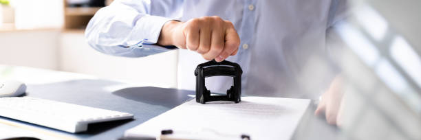 istock Person's Hand Stamping With Approved Stamp 1409041108