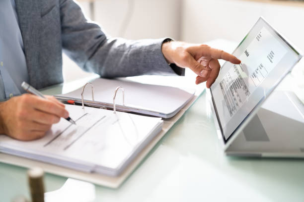 istock Businessman's Hands Working On Invoice On Laptop 1409041251
