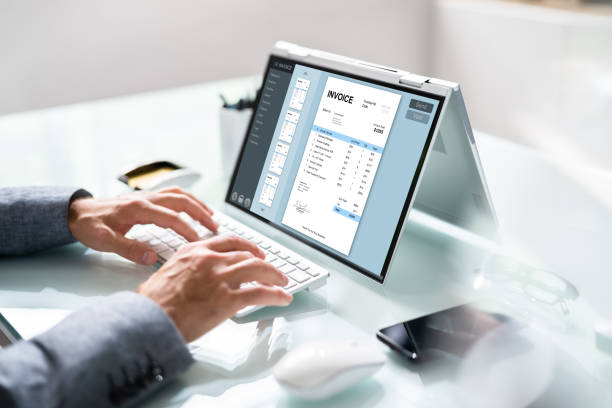 istock Businessperson Analyzing Invoice On Laptop 1409041590