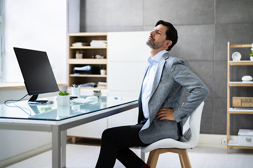 Bad Posture Sitting In Office With Backache In Chair