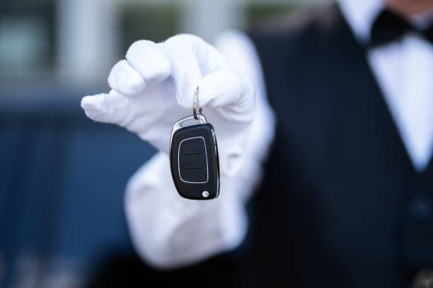 istock Valet Boy Hand Holding Car Key Outside 1409041720