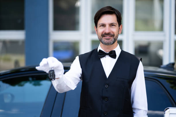 istock Valet Boy Hand Holding Car Key Outside 1409041726