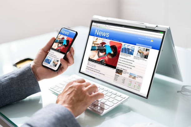 istock Watching News On Screen. Reading Newspaper Website 1409041762