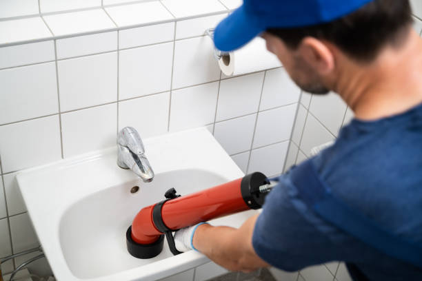 istock Plumber Cleaning Drain And Bathroom Sink 1409042382