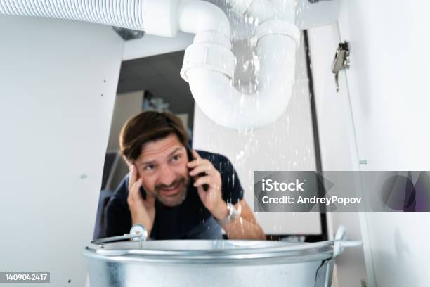 Worried Man Calling Plumber Stock Photo - Download Image Now - Plumber, Water Pipe, Leaking