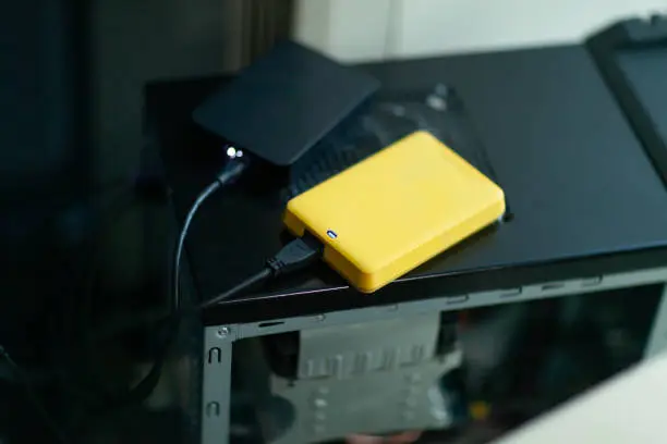 Photo of An external hard drive backup device connected to the computer