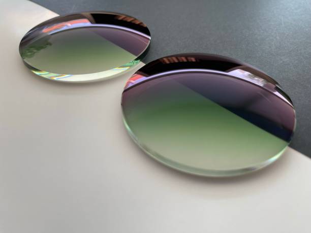 istock Two green gradient sun protection plastic eyeglass lens on Black - white background. 1409045560