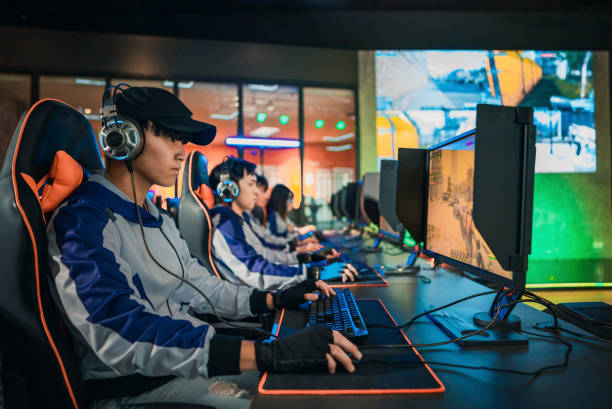 Asian Esports Team Gamer focus playing RPG First shooter Game in grand final sport event Championship Arena. Cyber Games Tournament Event stock photo